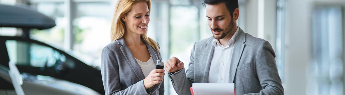 Woman and Man discuss car in dealerhsip