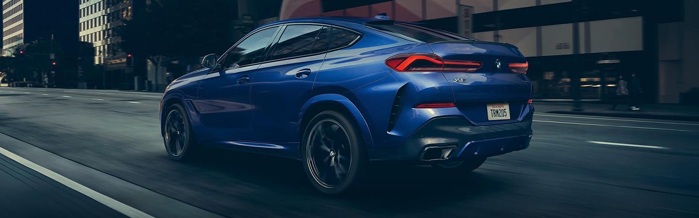 Blue 2020 BMW X6 in motion