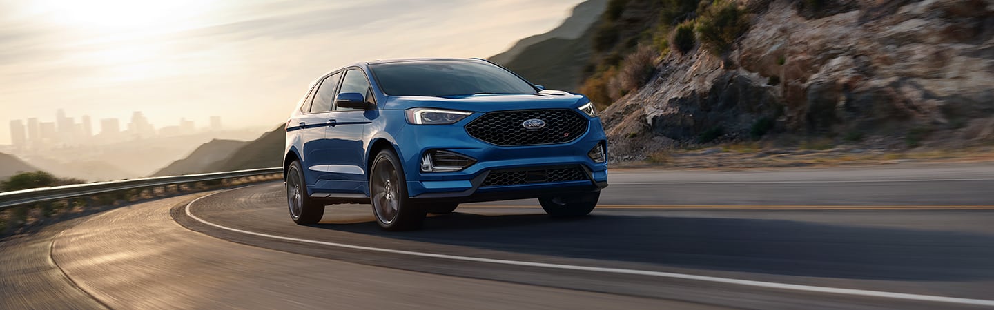 Blue 2020 Ford Edge driving along the highway