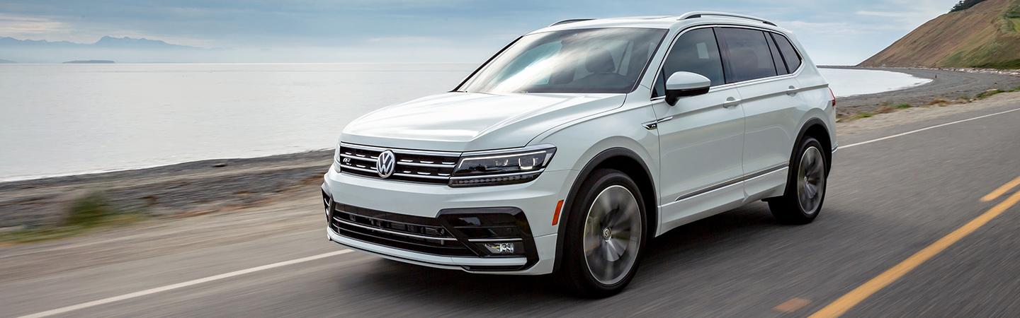 White Volkswagen Tiguan in motion near the ocean