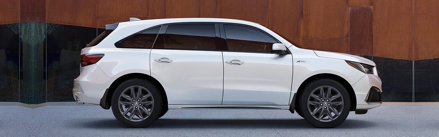 Passenger’s side profile of white MDX parked