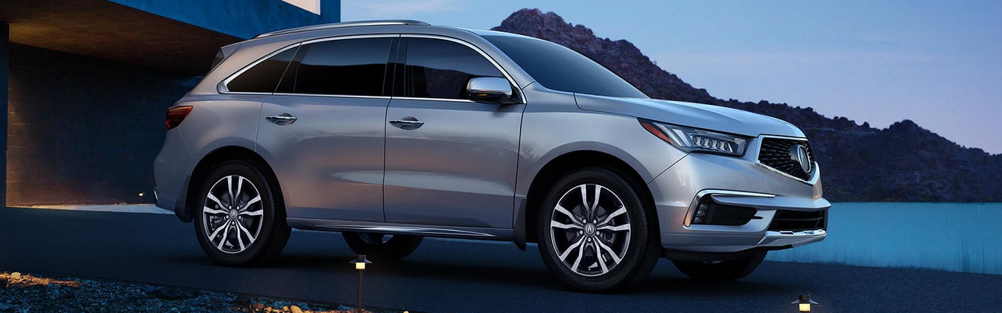 Passenger’s side profile of silver MDX parked