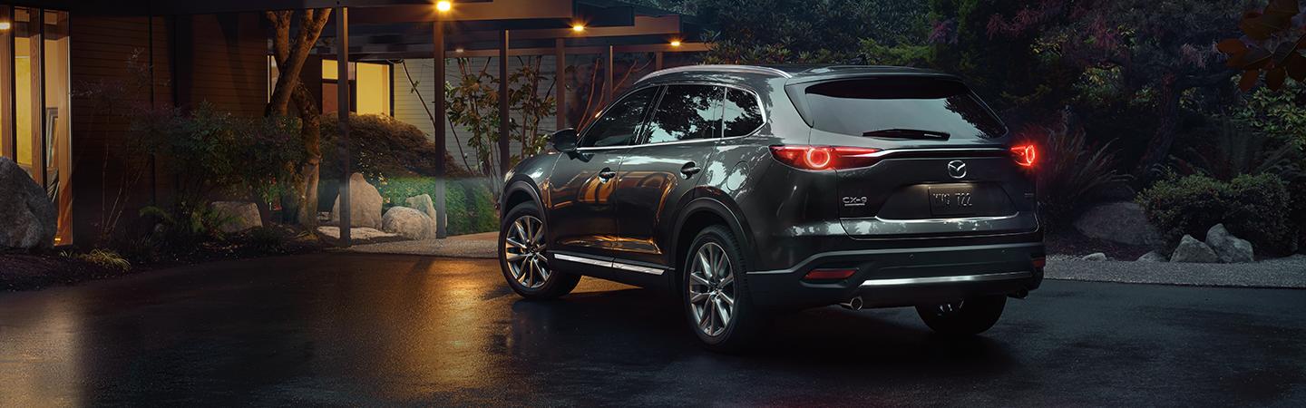Rear view of the 2020 Mazda CX-9 in motion in a city