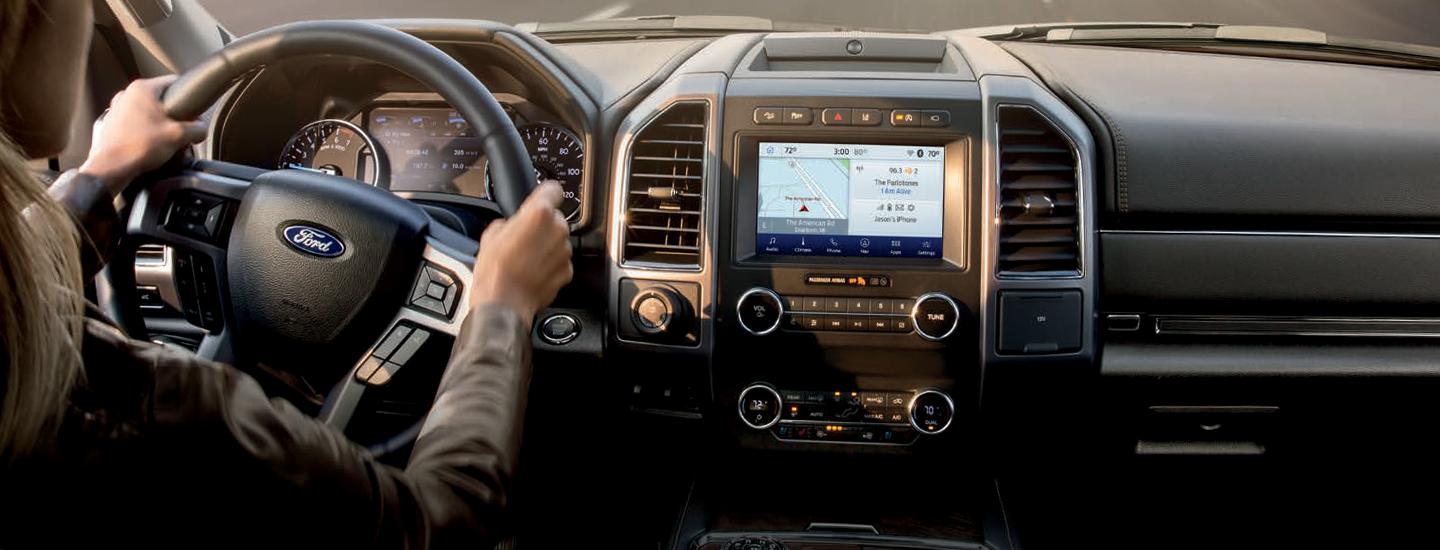 Close up of steering wheel and infotainment system in 2021 Ford Expedition