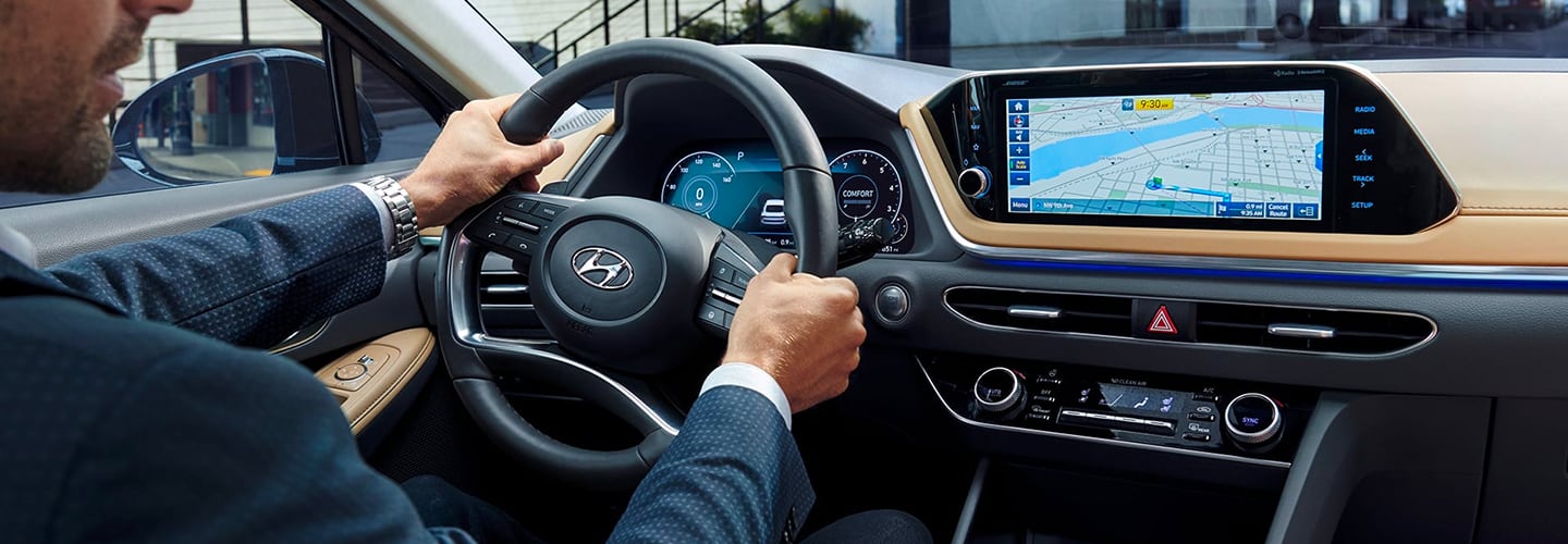 Man turning steering wheel in new Sonata