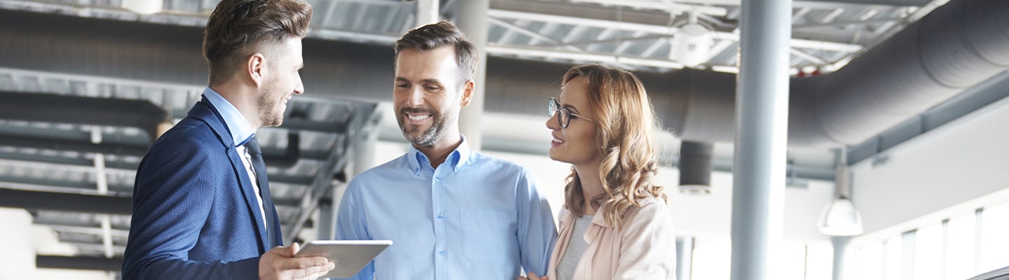 Sales associate working with customers on buying a new car