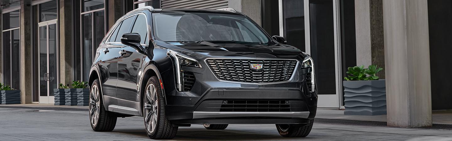 Front view of a black 2021 Cadillac XT4 in motion