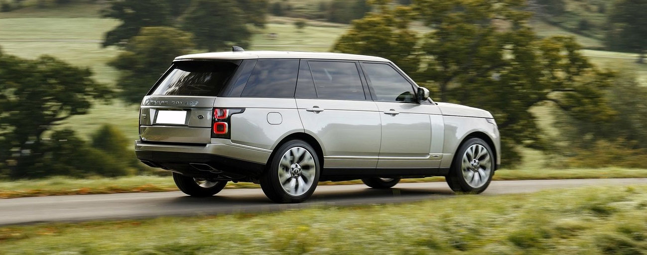 2019 Range Rover driving in country in motion view.