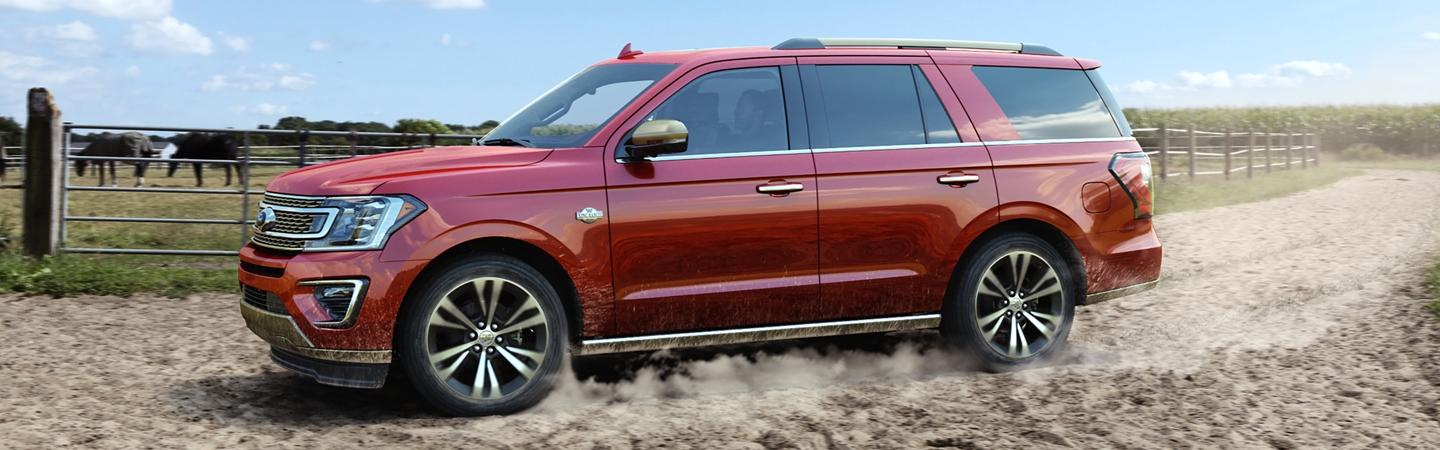 Red 2020 Ford Expedition driving on a dirt road