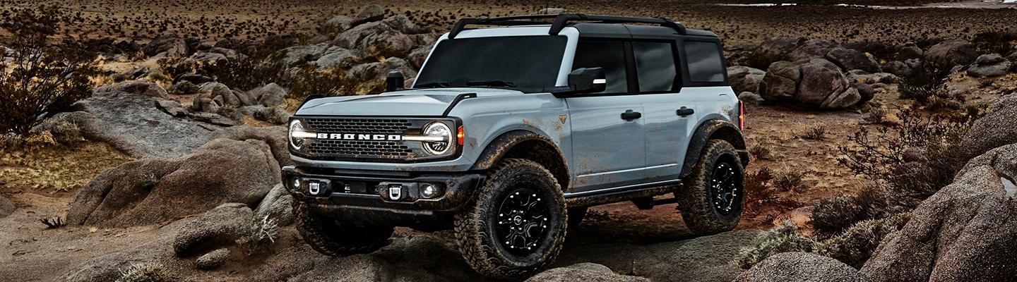 Angled profile of a 2021 Ford Bronco Sport parked on rugged terrain.