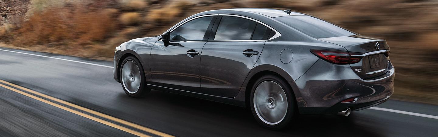 Rear side view of the 2020 Mazda6 in motion