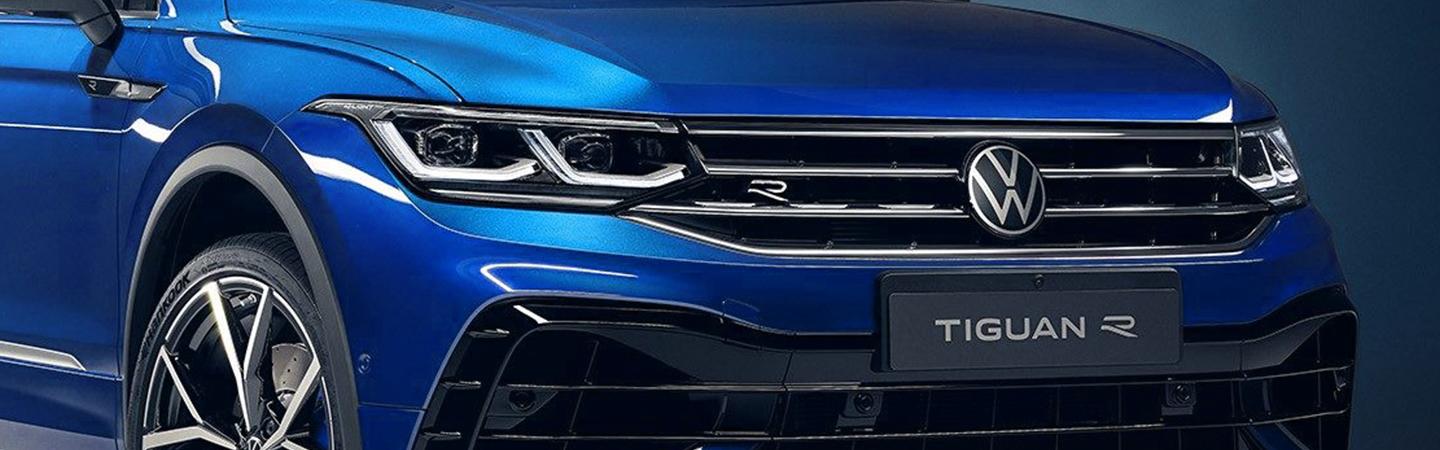 Close-up of the front grille and headlights of a blue Volkswagen Tiguan.