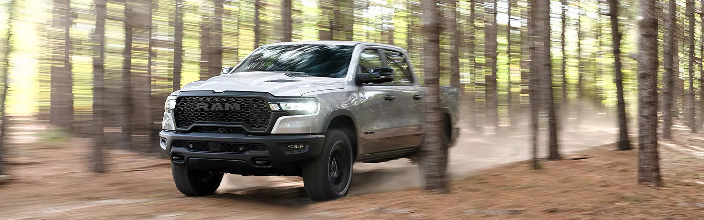 2026 RAM 1500 driving through the woods