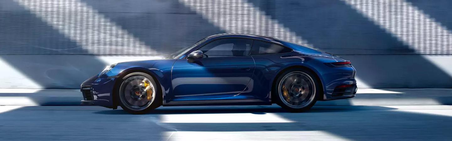 Side profile view of a blue Porsche