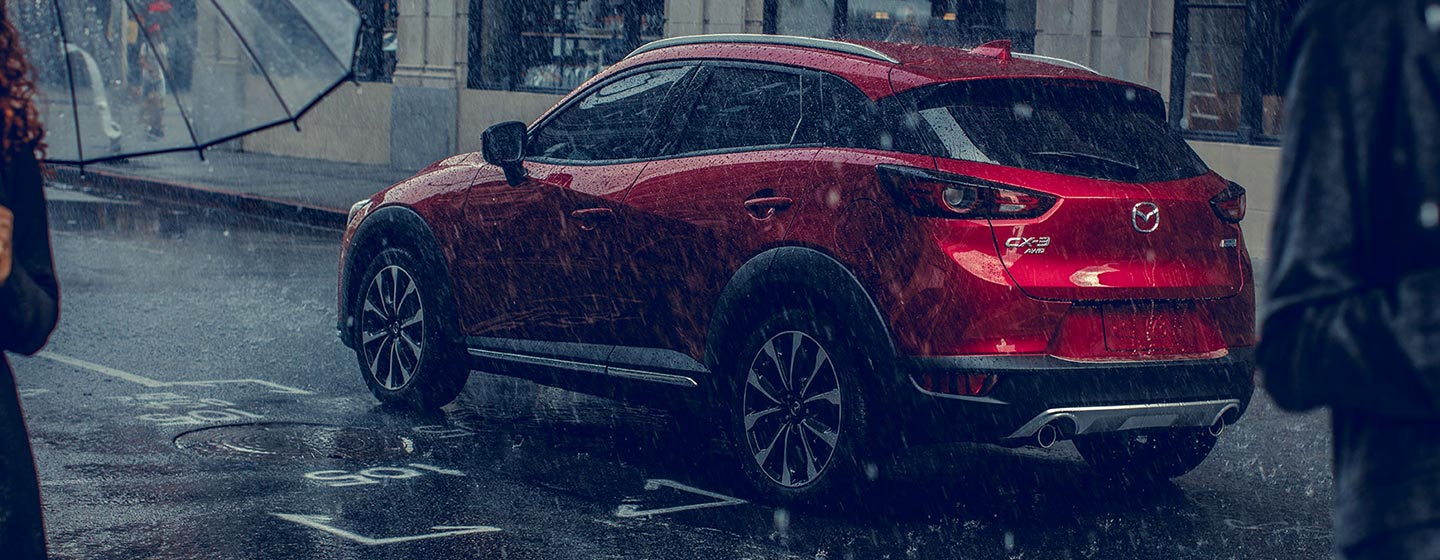 2019 Mazda CX-3 drivers side view dringin in rain.