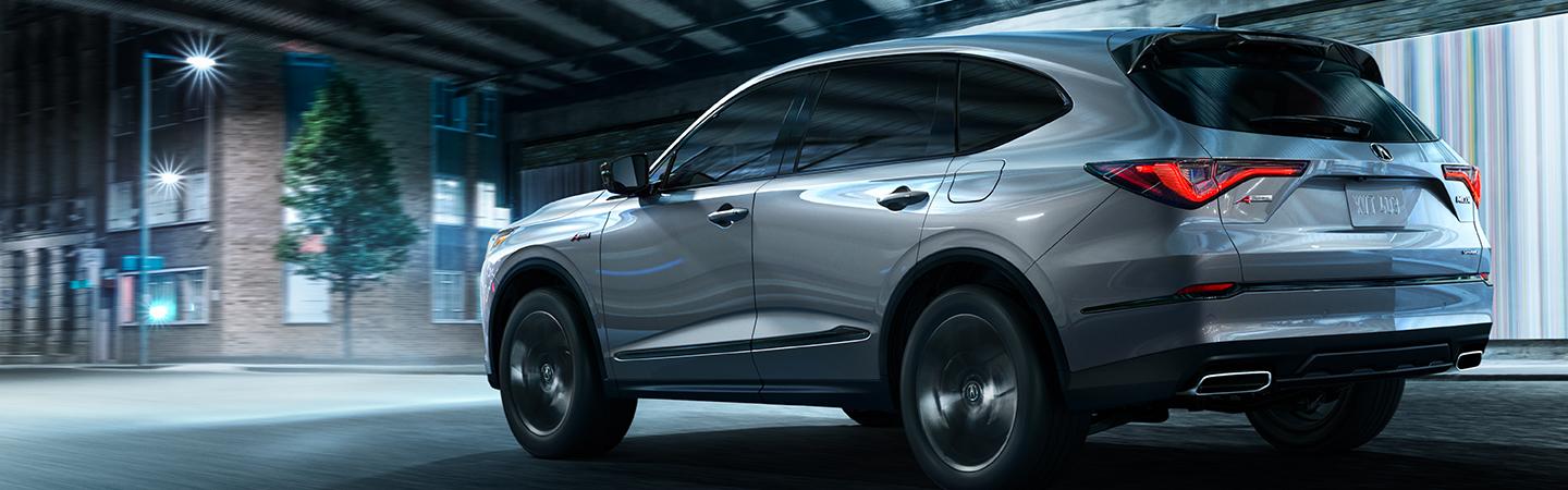 Full driver-side rear view of the Acura MDX in motion