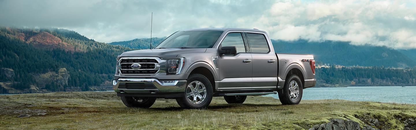 A red Ford F-150 tailgate down at night