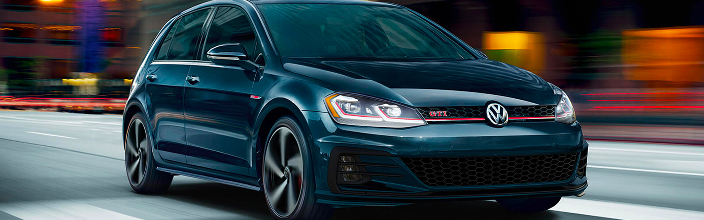 Front view of a dark blue 2020 Volkswagen Golf GTI in motion
