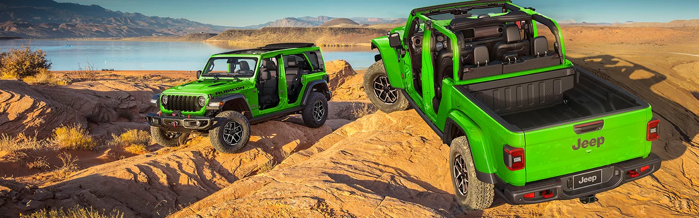 a bright green 2026 Jeep Wrangler Rubicon 39 offroading on rocks