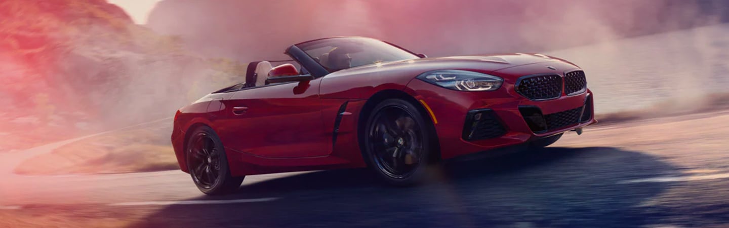 Side view of a red 2020 BMW Z4 driving