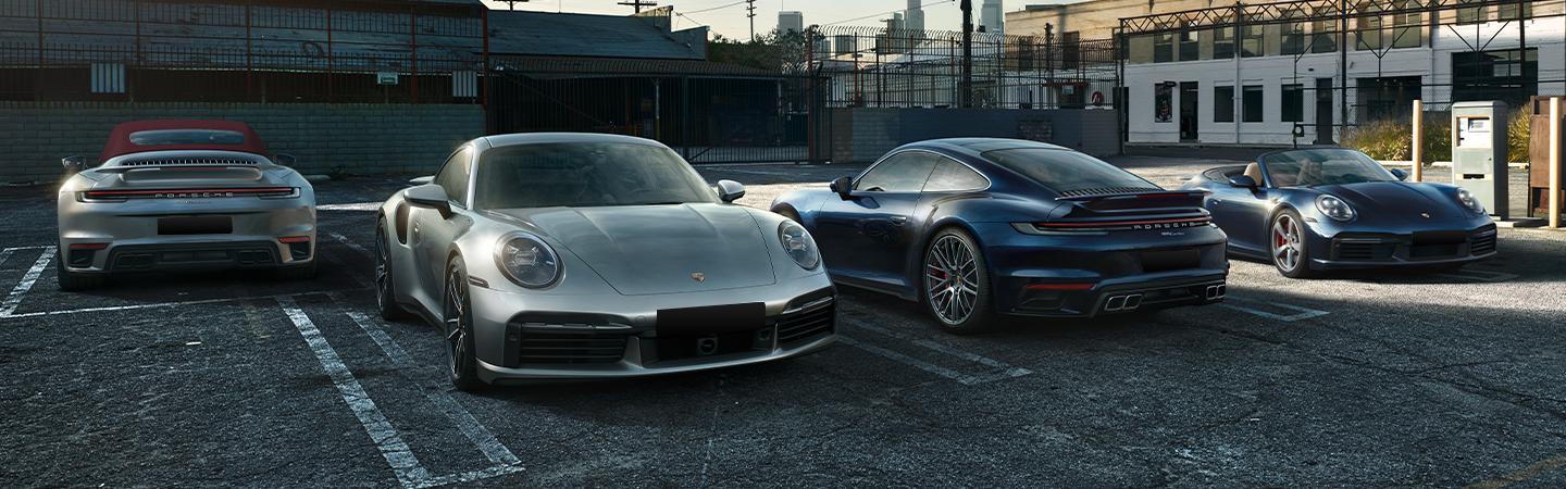 Four 2021 Porsche 911 models in a parking lot