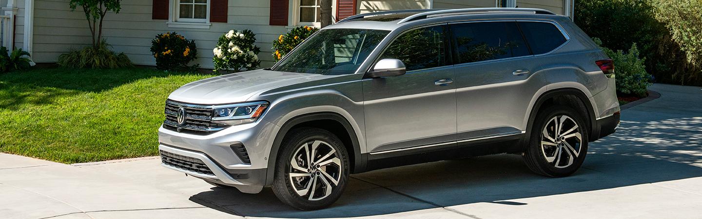 Side view of a silver 2021 Volkswagen Atlas parked in a driveway