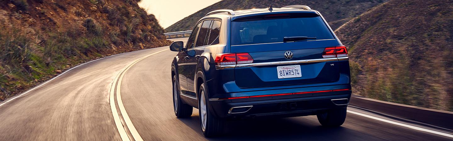 Rear view of a blue 2021 Volkswagen Atlas driving on the highway