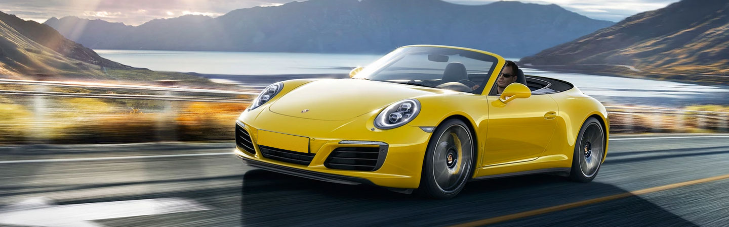 Yellow Porsche 911 Carrera in motion