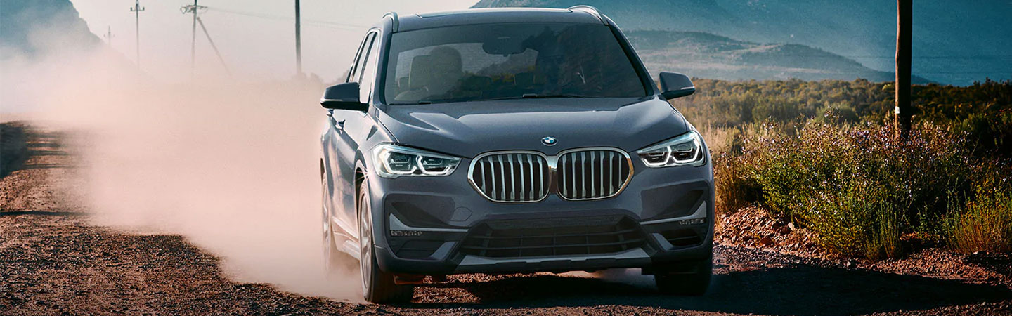 Gray BMW X series front view in motion