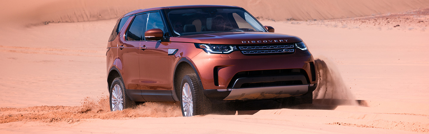 2019 Land Rover Discovery driving through the desert, available at Land Rover Ocala