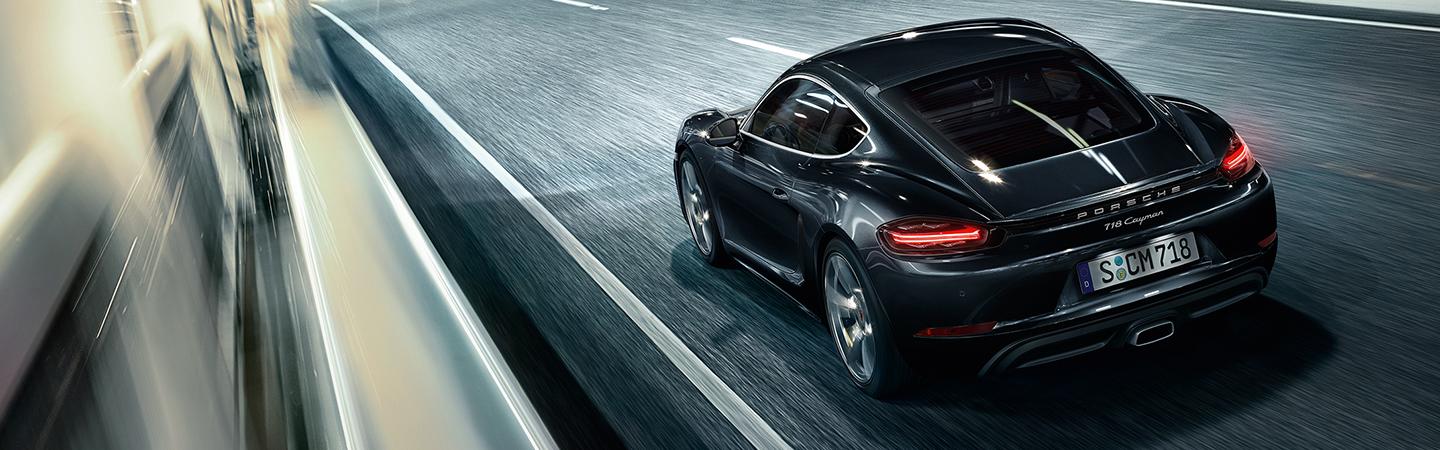 Rear view of the 2021 Porsche 718 Cayman in motion
