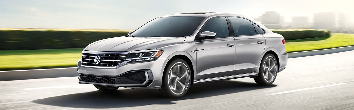 Driver’s side view of silver Passat in motion