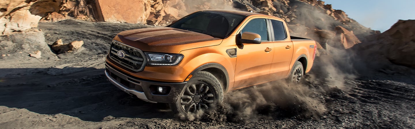 Orange 2020 Ford Ranger driving through dirt road