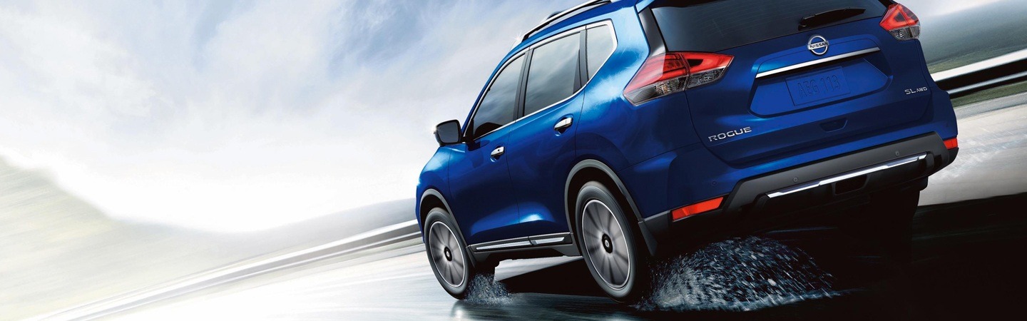 Gray Porsche Macan driving in a city