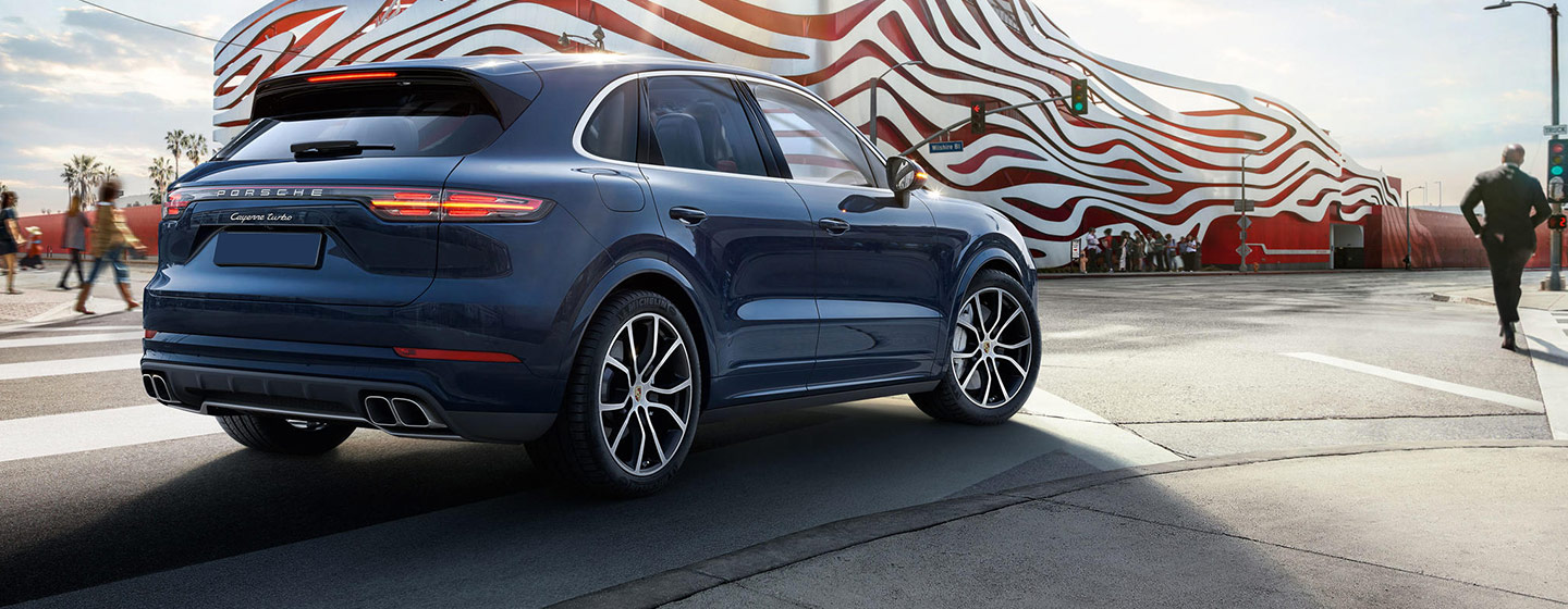 2019 Porsche Cayenne rear view parked at a stoplight.