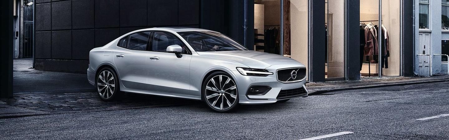 Side view of white Volvo S60 in motion