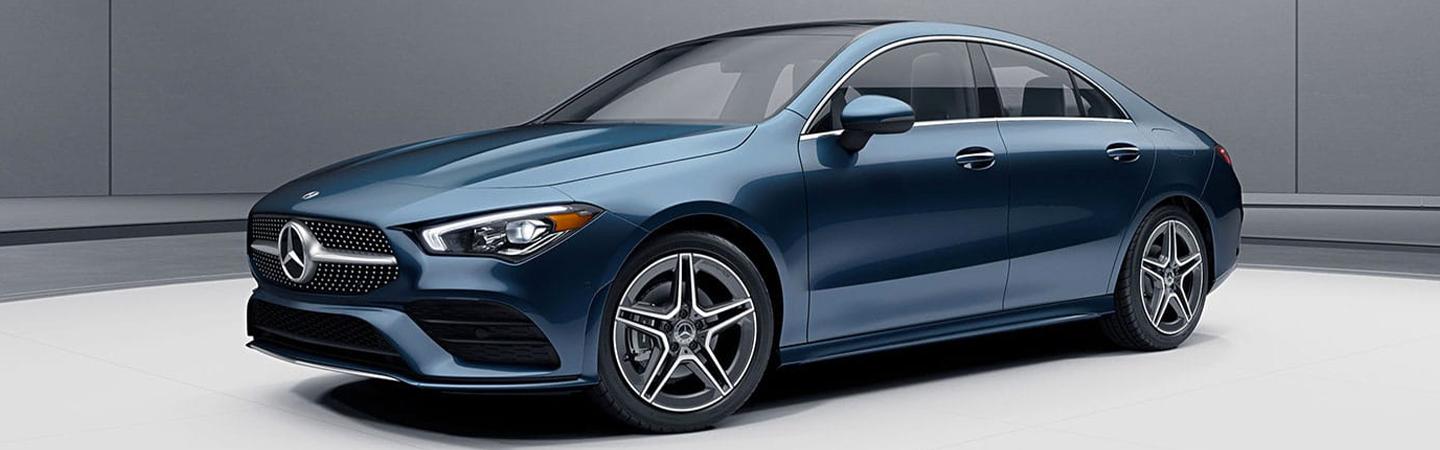 Blue CLA parked on a white platform