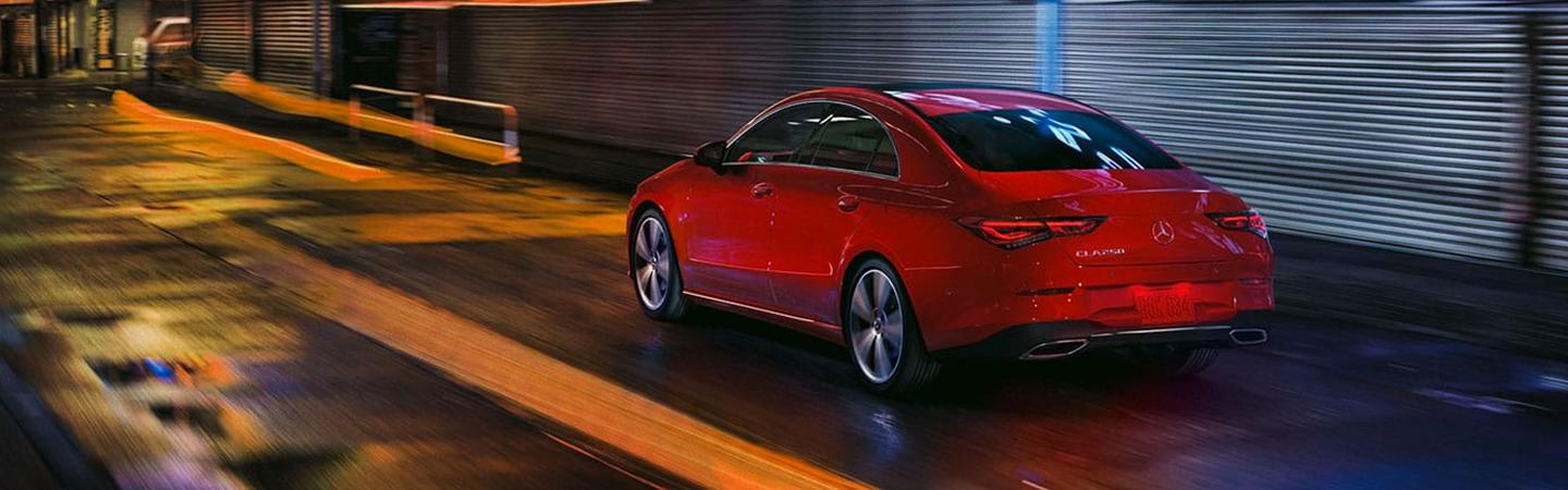 Rear view of red CLA driving at night