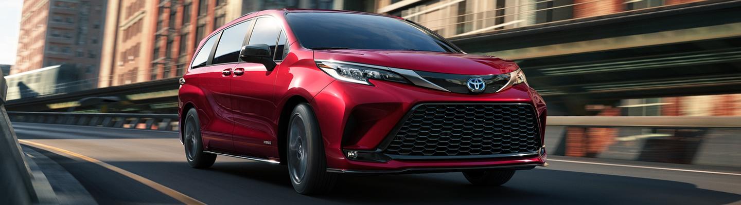 Red Toyota Sienna Driving on the Road