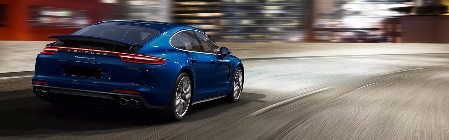 Rear view of blue Panamera in motion