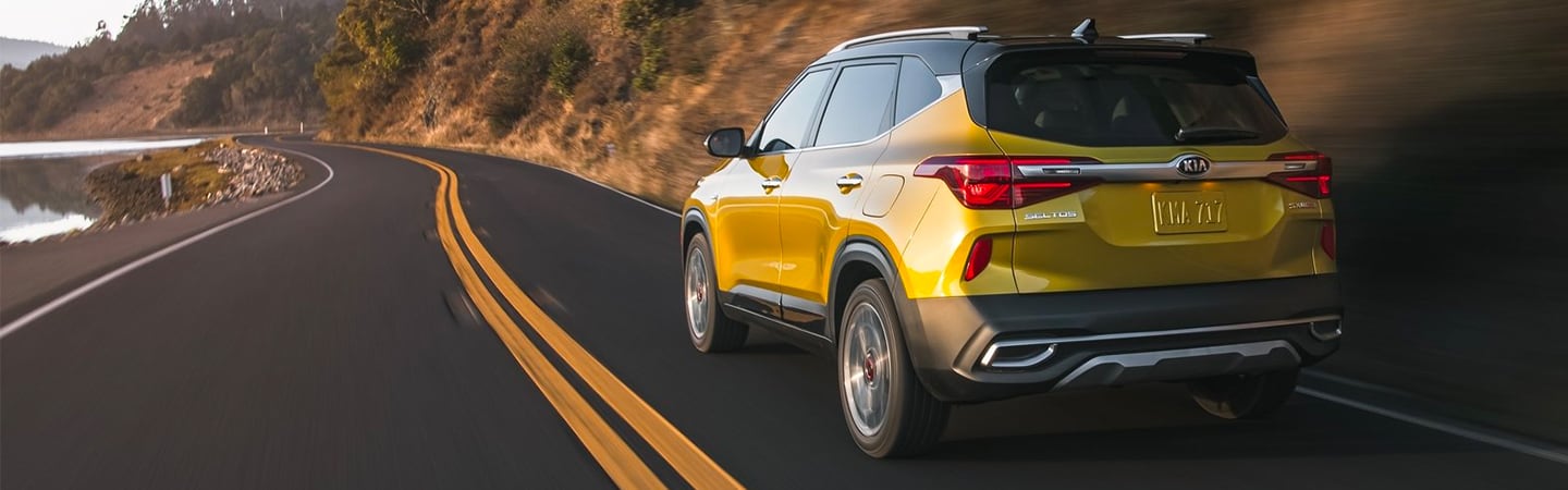 2021 Kia Seltos driving near a lake