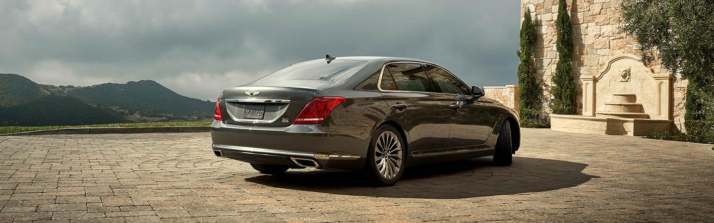 Rear view of a silver G90 parked