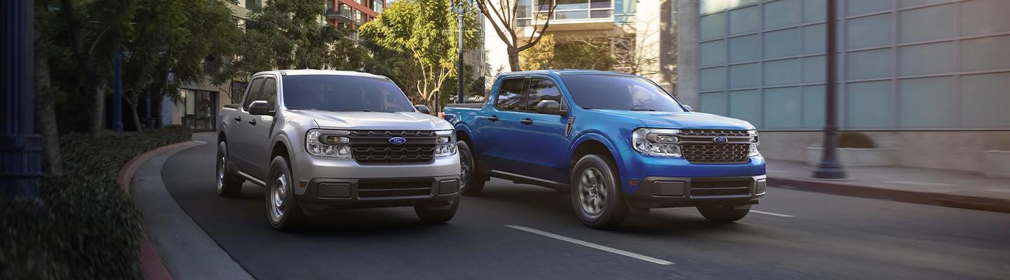 Two 2022 Ford Maverick trucks in motion front view