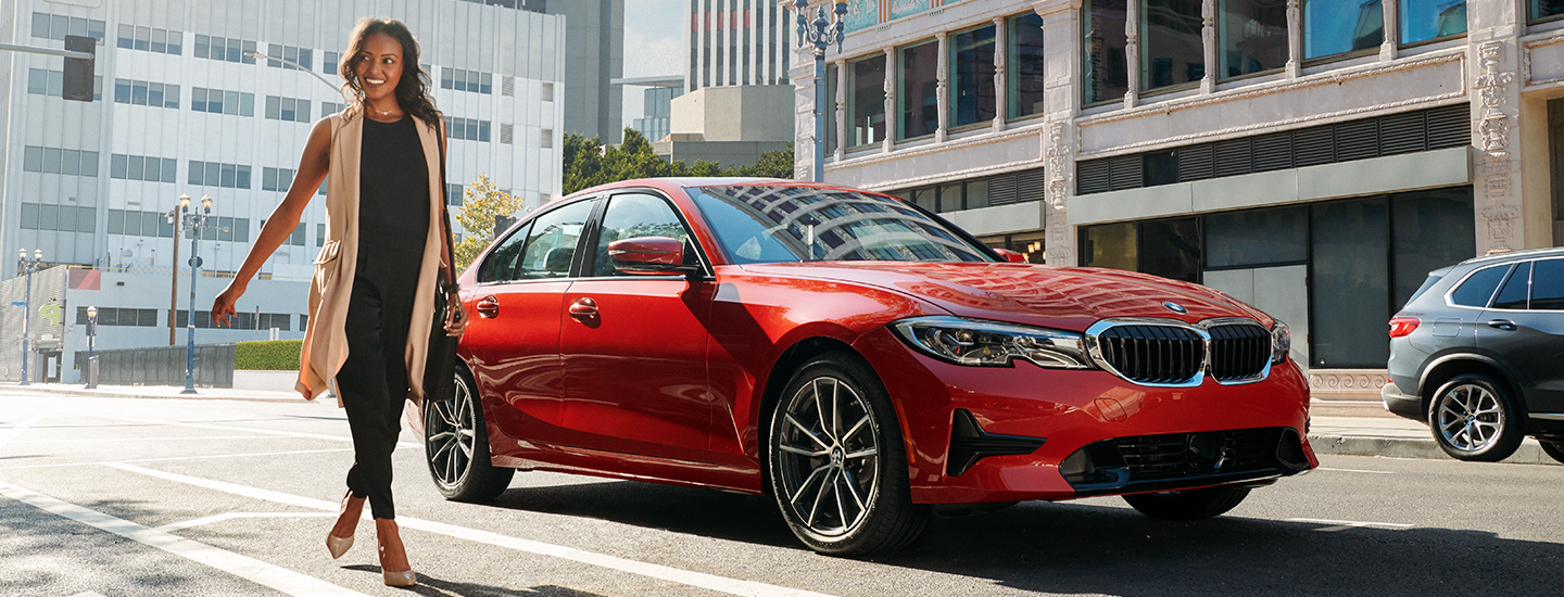 Side view of a red 2021 BMW 3 Series parked 