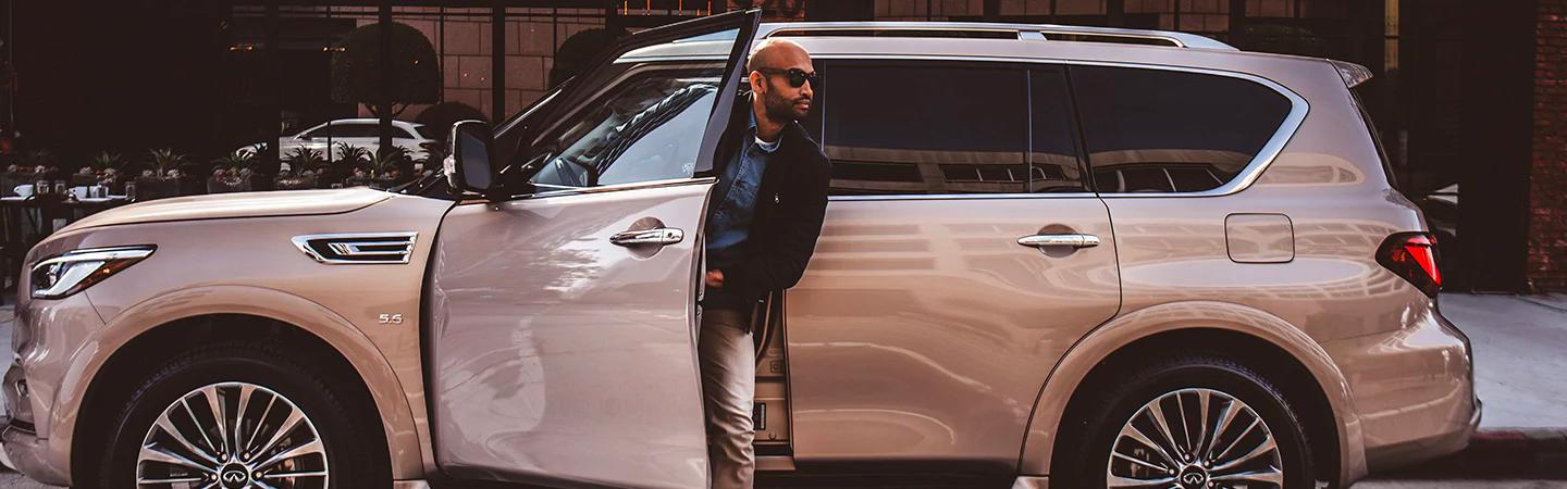 A man getting off the 2020 LExus QX80