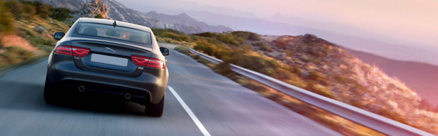 2019 Jaguar XE - Black - Rear View - Driving in the mountains