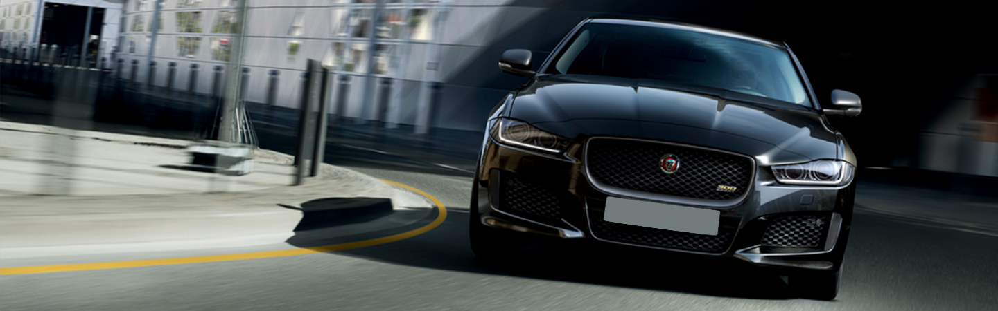 2019 Jaguar XE - Black - Front View - Driving around a corner