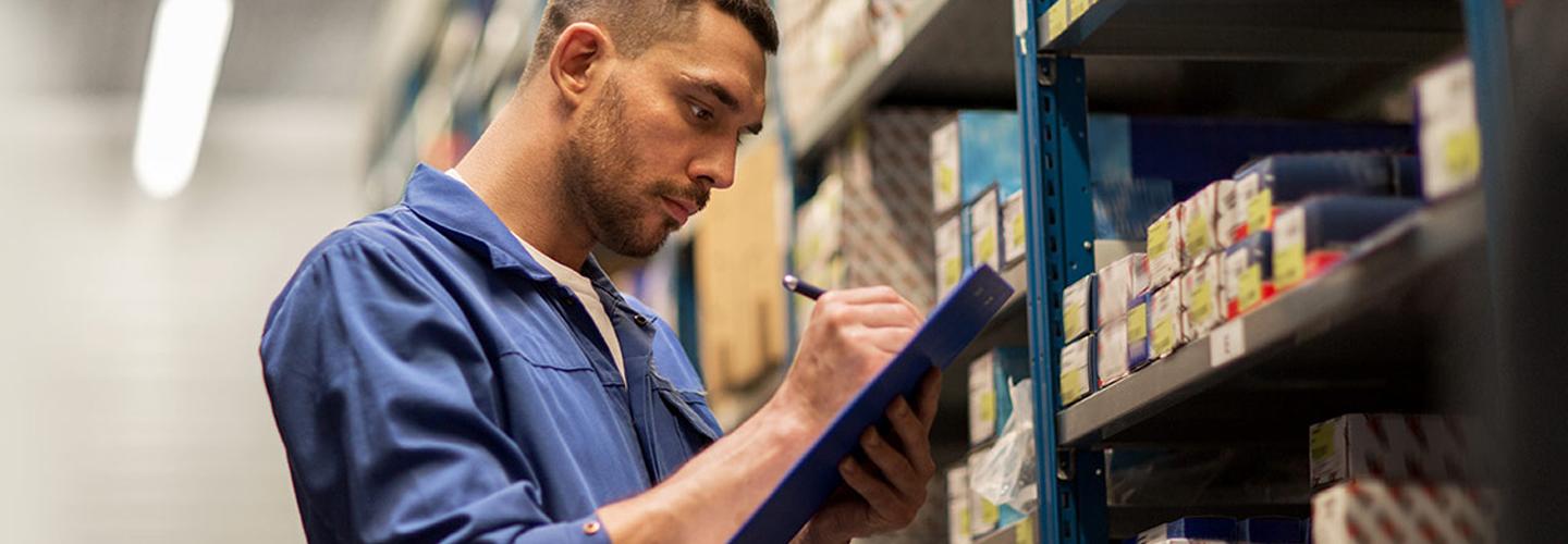 Parts employee checking inventory in parts department