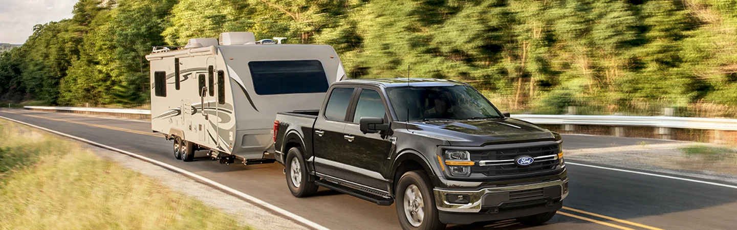 2025 Ford F-150 vs. Competition Black color car with track on highway view