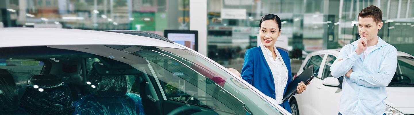 A customer and a sales team member looking at a new Hyundai